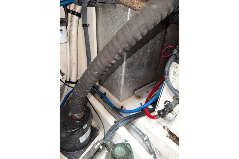 Slide: The Image of Engine compartment of 2006 Searay 290 AMBERJACK with hoses and mechanical components. - 19
