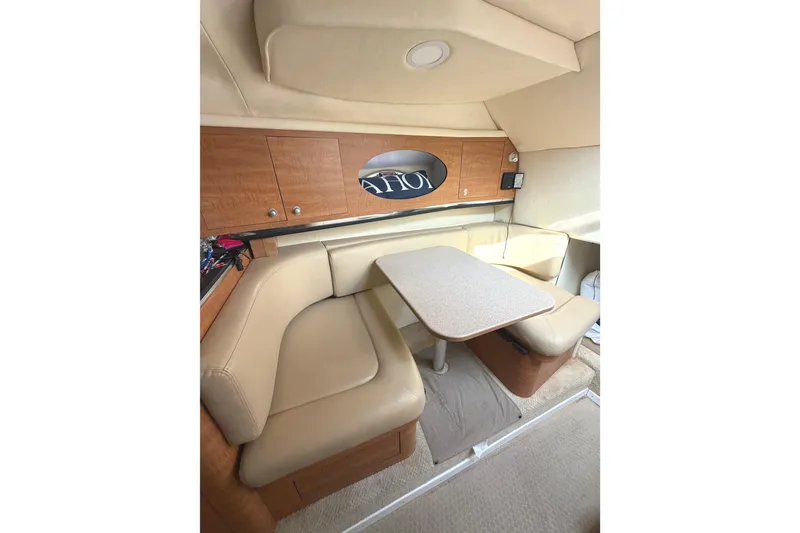 Slide: The Image of Interior of 2006 Searay 290 AMBERJACK boat with beige seating and wooden cabinetry. - 28