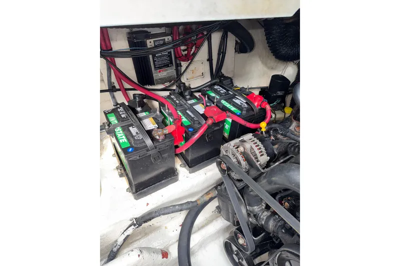 Slide: The Image of Engine compartment of 2006 Searay 290 AMBERJACK with batteries and wiring visible. - 16