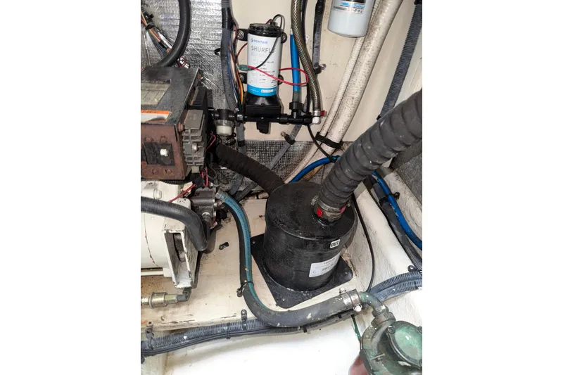 Slide: The Image of Engine compartment of 2006 Searay 290 AMBERJACK with visible hoses and components. - 17