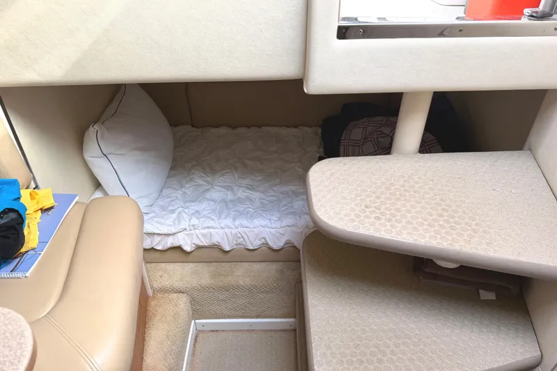 Slide: The Image of 2006 Searay 290 Amberjack cabin interior with bed, steps, and window view. - 30