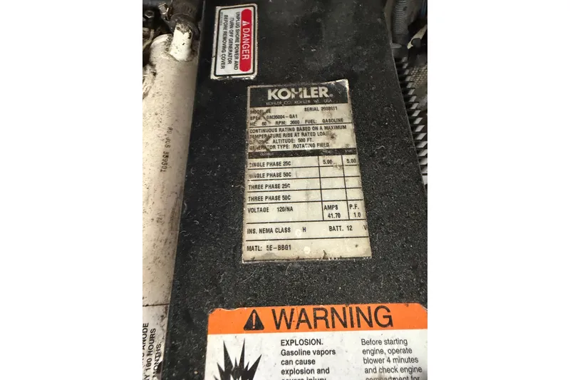 Slide: The Image of Kohler generator label with specifications and warning on a 2006 Searay 290 Amberjack. - 14