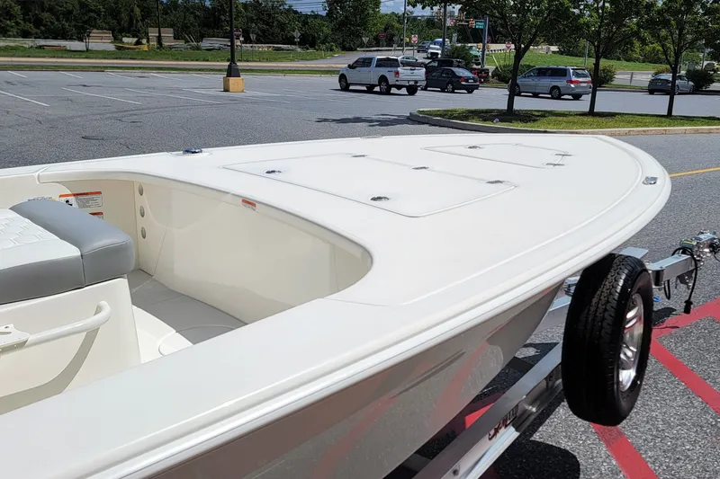Slide: The Image of 2026 Mako 18 Pro Skiff boat on trailer in parking lot. - 5