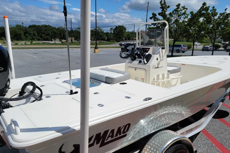 Slide: The Image of 2026 Mako 18 Pro Skiff boat in parking lot, showcasing sleek design and modern features. - 4