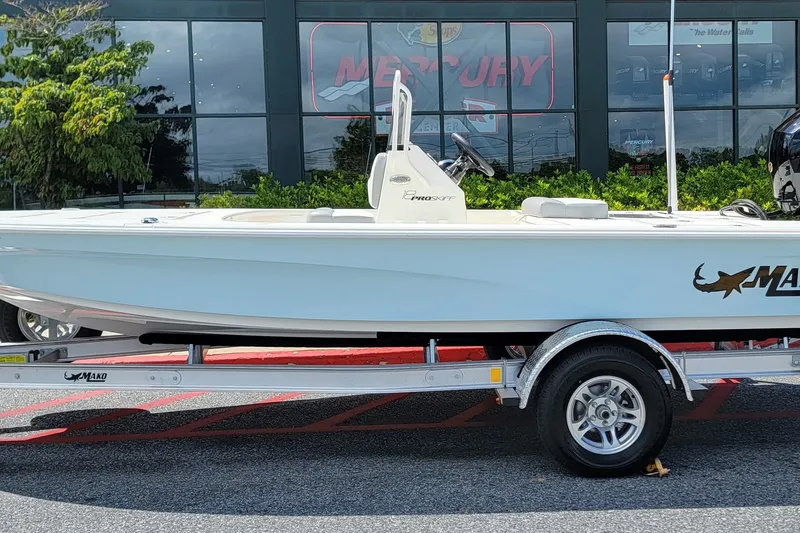 Slide: The Image of 2026 Mako 18 Pro Skiff boat on trailer outside dealership. - 1