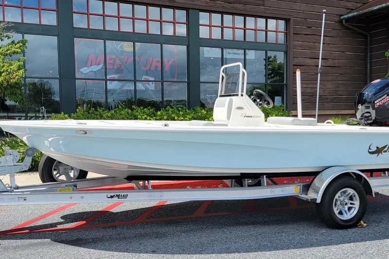 The Image of 2026 Mako 18 Pro Skiff boat on trailer outside dealership. - 0