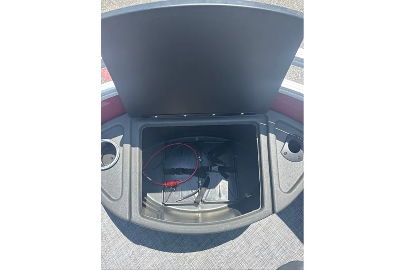 Slide: The Image of Open storage compartment on 2026 Sun Tracker Sportfish 24 XP3 boat, featuring cup holders. - 5