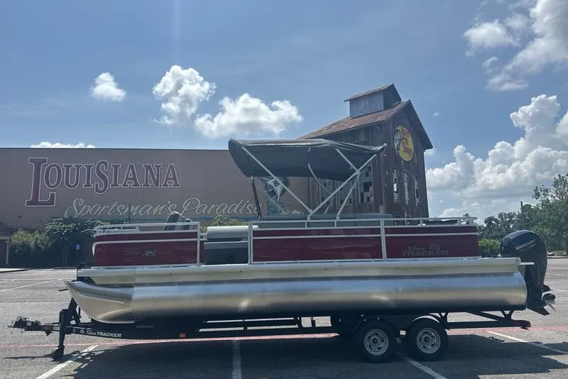 Slide: The Image of 2026 Sun Tracker Sportfish 24 XP3 pontoon boat parked in Louisiana. - 2