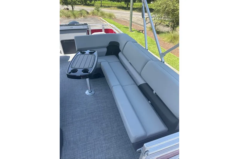 Slide: The Image of 2026 Sun Tracker Sportfish 24 XP3 pontoon boat interior with gray seating and table. - 8