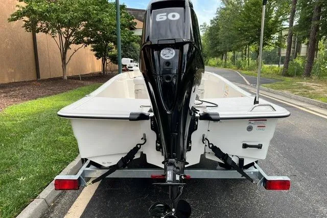 Slide: The Image of 2026 Mako Pro Skiff 15 CC boat on trailer, rear view with outboard motor. - 3