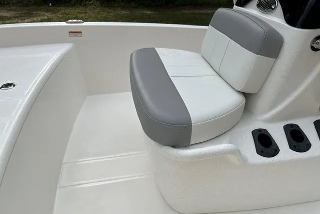 Slide: The Image of 2026 Mako Pro Skiff 15 CC boat interior with cushioned seating and console details. - 11