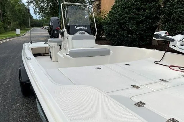 Slide: The Image of 2026 Mako Pro Skiff 15 CC boat on a road, featuring a sleek design. - 4