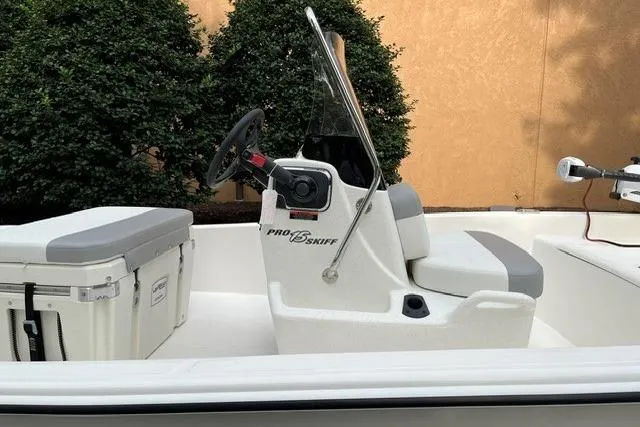 Slide: The Image of 2026 Mako Pro Skiff 15 CC boat interior with steering console and seating. - 5