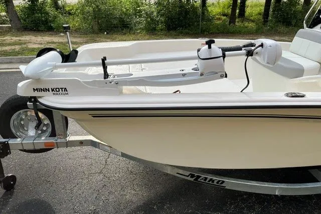 Slide: The Image of 2026 Mako Pro Skiff 15 CC with Minn Kota Maxxum motor on trailer. - 8