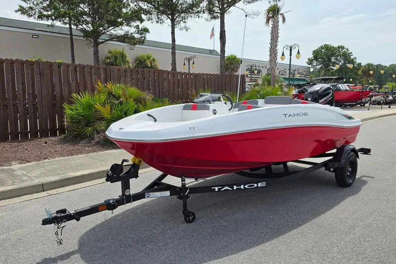 Slide: The Image of 2026 Tahoe T16 boat in red and white on a trailer, parked outdoors. - 10