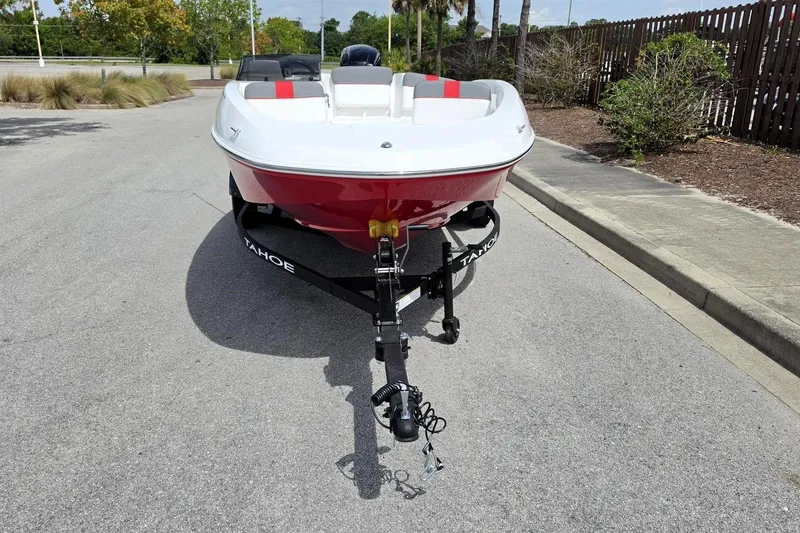 Slide: The Image of 2026 Tahoe T16 boat on trailer, parked on a sunny street. - 7