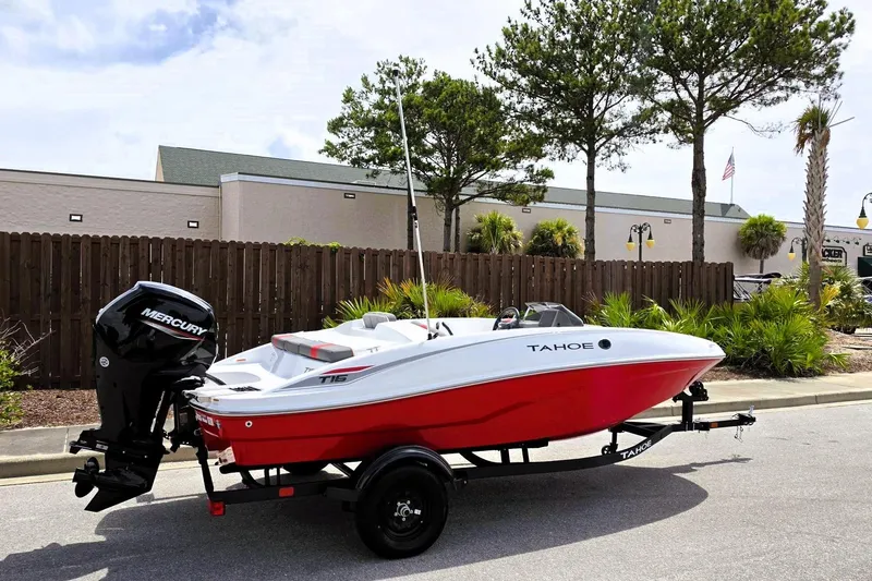 Slide: The Image of 2026 Tahoe T16 boat with Mercury engine on trailer, parked outdoors. - 1