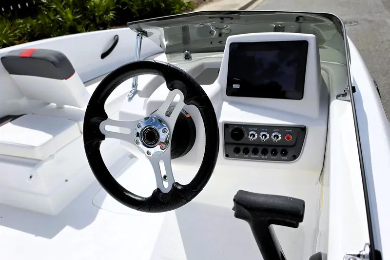Slide: The Image of 2026 Tahoe T16 boat dashboard with steering wheel and control panel. - 14