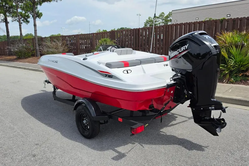 Slide: The Image of 2026 Tahoe T16 boat with Mercury engine, red and white design, parked on a street. - 11