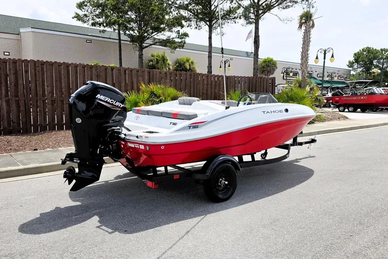 Slide: The Image of 2026 Tahoe T16 boat with Mercury engine on trailer, parked outdoors. - 2