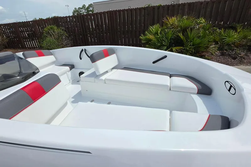 Slide: The Image of 2026 Tahoe T16 boat interior with white and red seating, outdoor setting. - 16