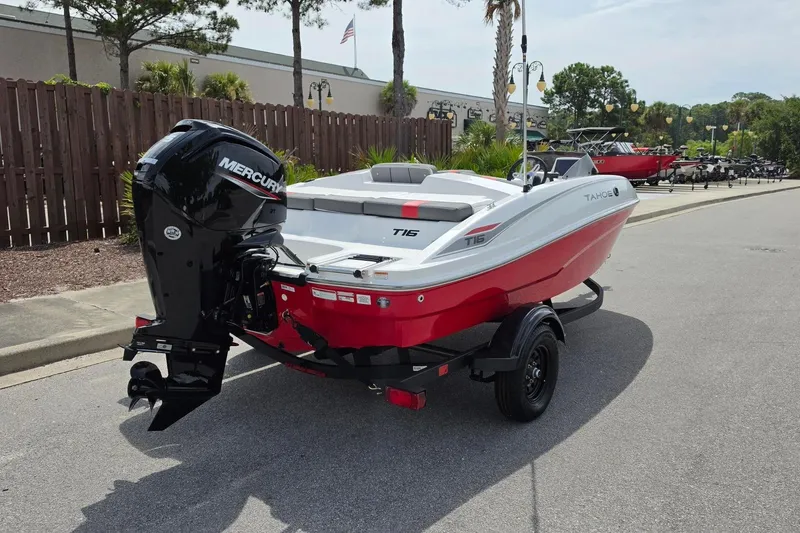 Slide: The Image of 2026 Tahoe T16 boat with Mercury engine on trailer, parked outdoors. - 3
