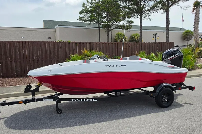 Slide: The Image of 2026 Tahoe T16 boat in red and white on a trailer, parked outdoors. - 9