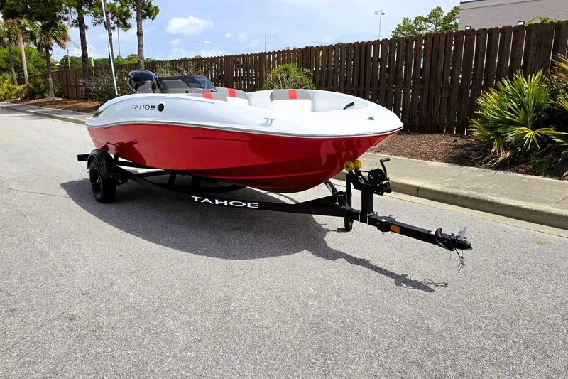 Slide: The Image of 2026 Tahoe T16 boat on trailer, red and white design, parked on street. - 5