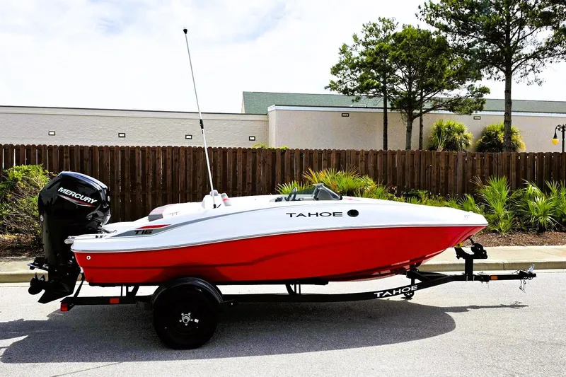 The Image of 2026 Tahoe T16 boat with Mercury engine on trailer, parked outdoors. - 0