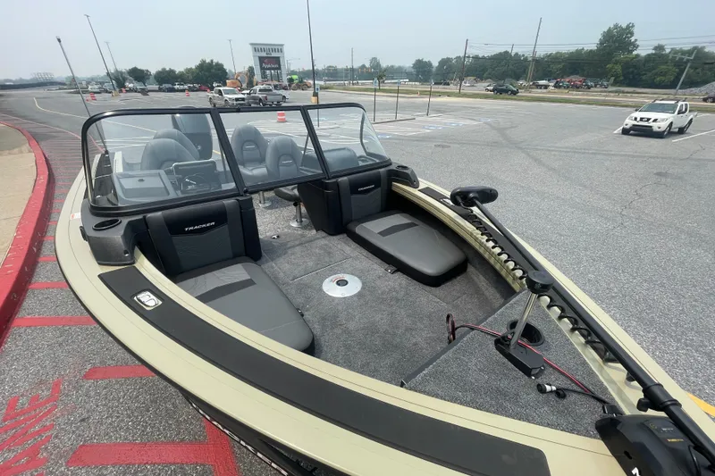 Slide: The Image of 2026 Tracker Targa V-19 Combo boat in parking lot, showcasing seating and controls. - 2