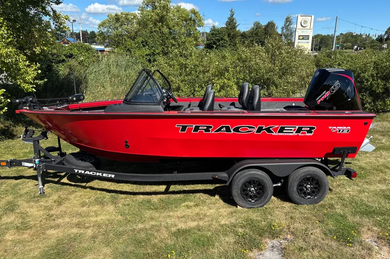 The Image of 2026 Tracker Targa V-18 WT boat on trailer, vibrant red, parked on grass. - 0