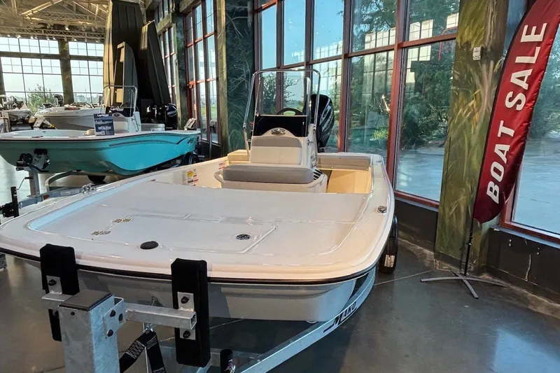 Slide: The Image of 2026 Mako Pro Skiff 13 CC displayed indoors with a "Boat Sale" sign. - 4