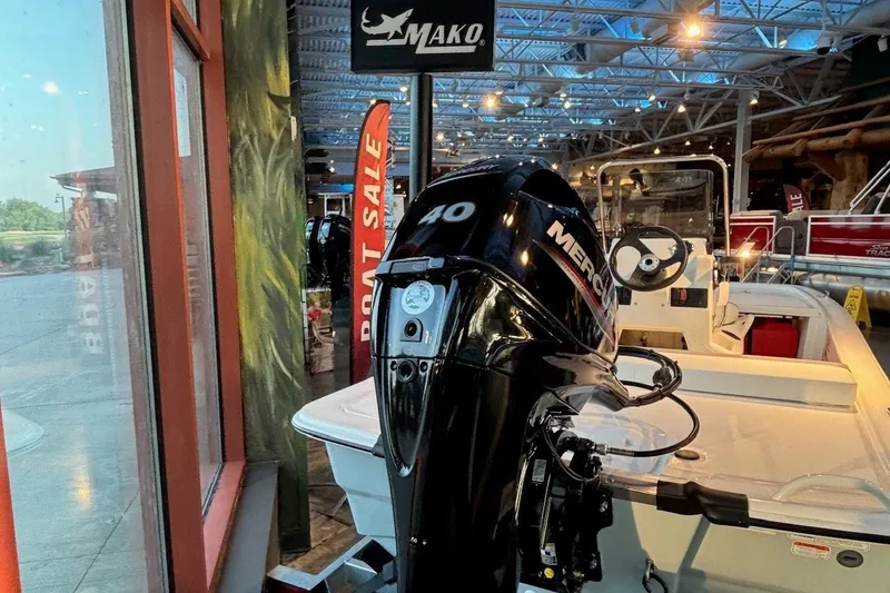 Slide: The Image of 2026 Mako Pro Skiff 13 CC boat with Mercury engine on display in showroom. - 11