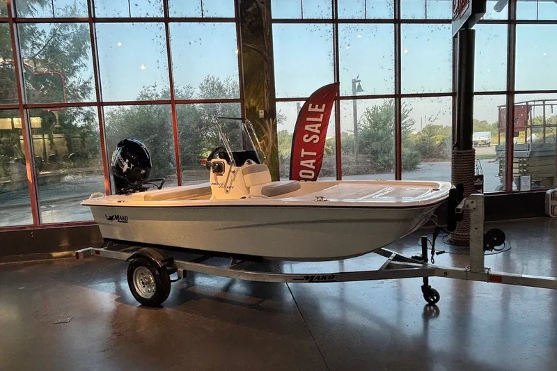 The Image of 2026 Mako Pro Skiff 13 CC boat on display indoors with "Boat Sale" sign. - 0