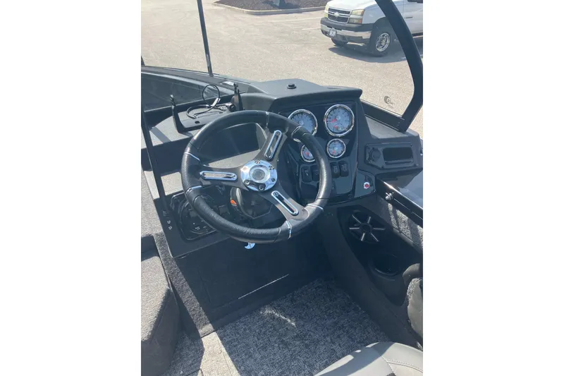 Slide: The Image of 2026 Tracker Targa V-19 Combo boat dashboard with steering wheel and gauges. - 7