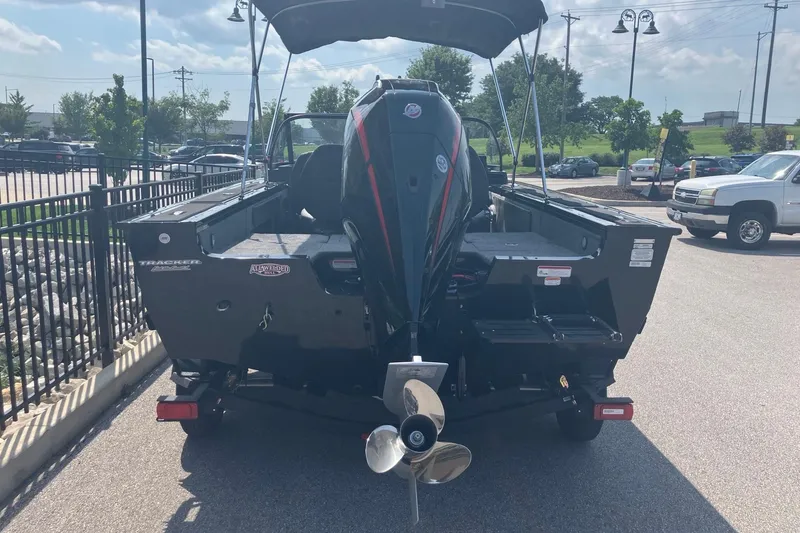 Slide: The Image of 2026 Tracker Targa V-19 Combo boat with outboard motor, parked outdoors. - 2