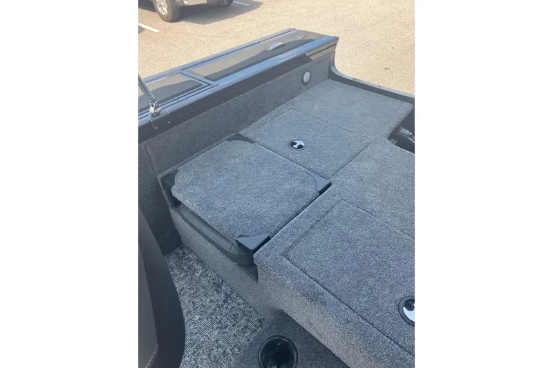 Slide: The Image of 2026 Tracker Targa V-19 Combo boat interior with gray carpeted seating and storage compartments. - 10