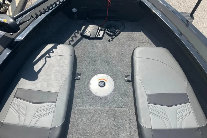 Slide: The Image of Interior of 2026 Tracker Targa V-19 Combo boat with seating and pedal controls. - 6