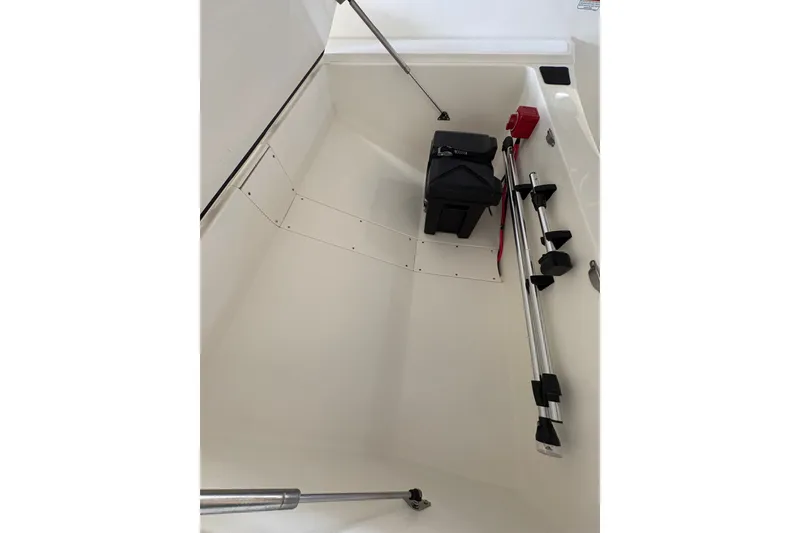 Slide: The Image of Interior of 2026 Mako Pro Skiff 17 CC boat with storage compartment. - 13