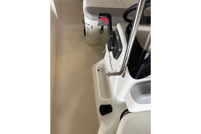 Slide: The Image of Interior view of a 2026 Mako Pro Skiff 17 CC boat, featuring steering controls. - 58