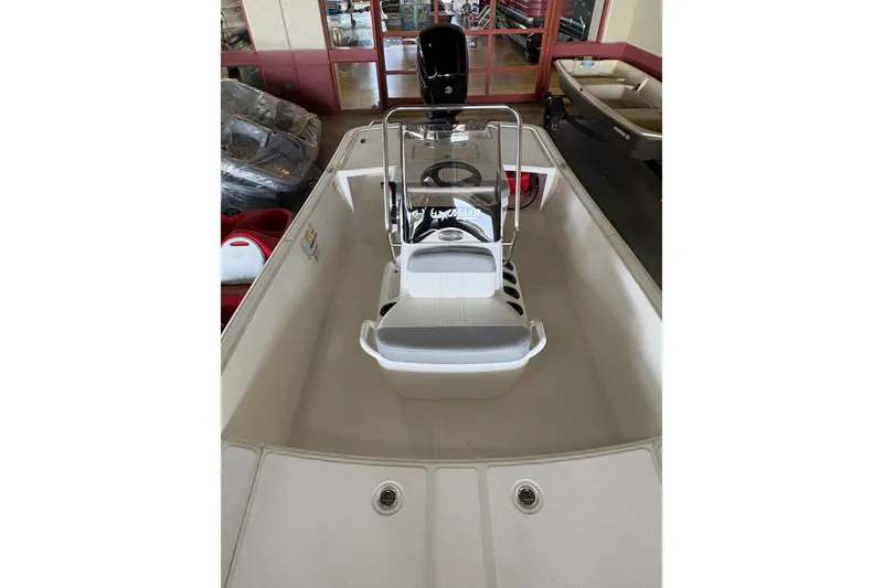 Slide: The Image of 2026 Mako Pro Skiff 17 CC boat interior with center console and seating. - 10