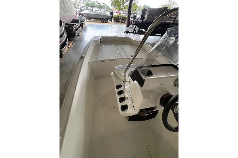 Slide: The Image of 2026 Mako Pro Skiff 17 CC boat interior with console and seating area. - 65