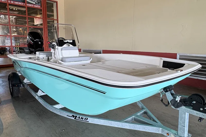 Slide: The Image of A 2026 Mako Pro Skiff 17 CC on a trailer in an indoor setting. - 7
