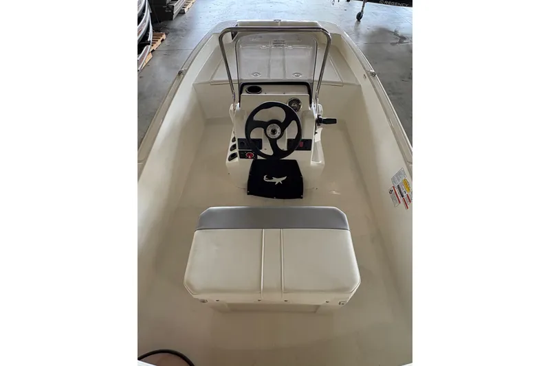 Slide: The Image of 2026 Mako Pro Skiff 17 CC boat interior with steering console and seating. - 9