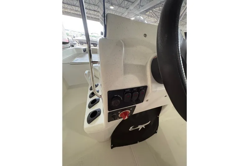 Slide: The Image of 2026 Mako Pro Skiff 17 CC console with steering wheel and control panel. - 63