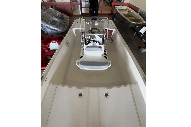 Slide: The Image of The image shows a 2026 Mako Pro Skiff 17 CC boat with a central console. - 8