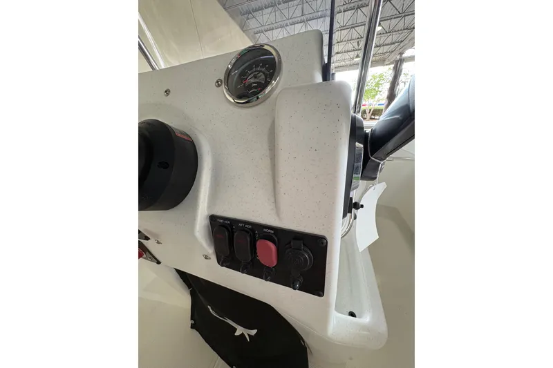 Slide: The Image of 2026 Mako Pro Skiff 17 CC dashboard with gauges and controls in a showroom. - 64