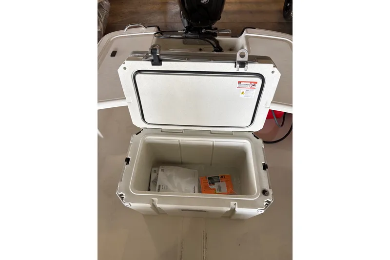 Slide: The Image of Open storage compartment on 2026 Mako Pro Skiff 17 CC boat, showing interior space. - 60