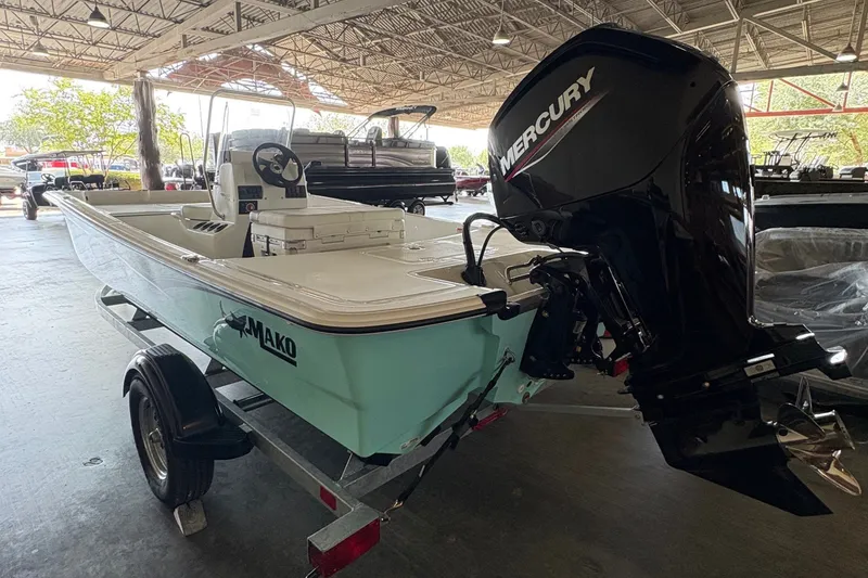 Slide: The Image of A 2026 Mako Pro Skiff 17 CC on a trailer inside a warehouse. - 3