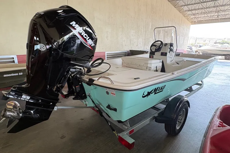 Slide: The Image of A 2026 Mako Pro Skiff 17 CC on a trailer in a covered storage area. - 5